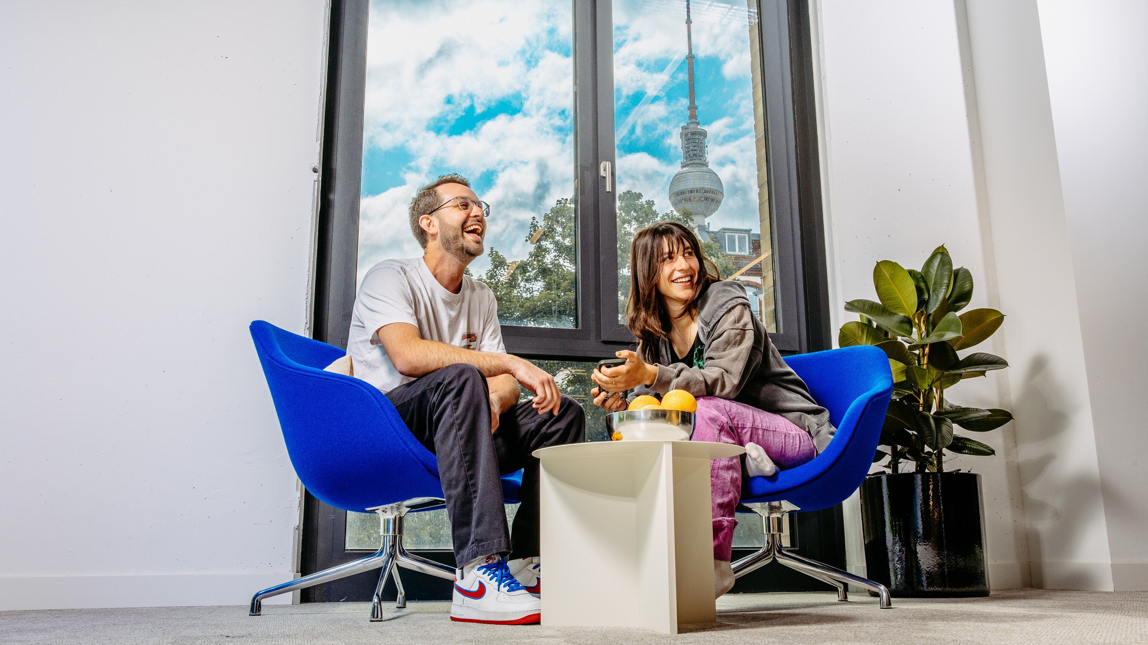 Metacoreans sitting in their Berlin office laughing