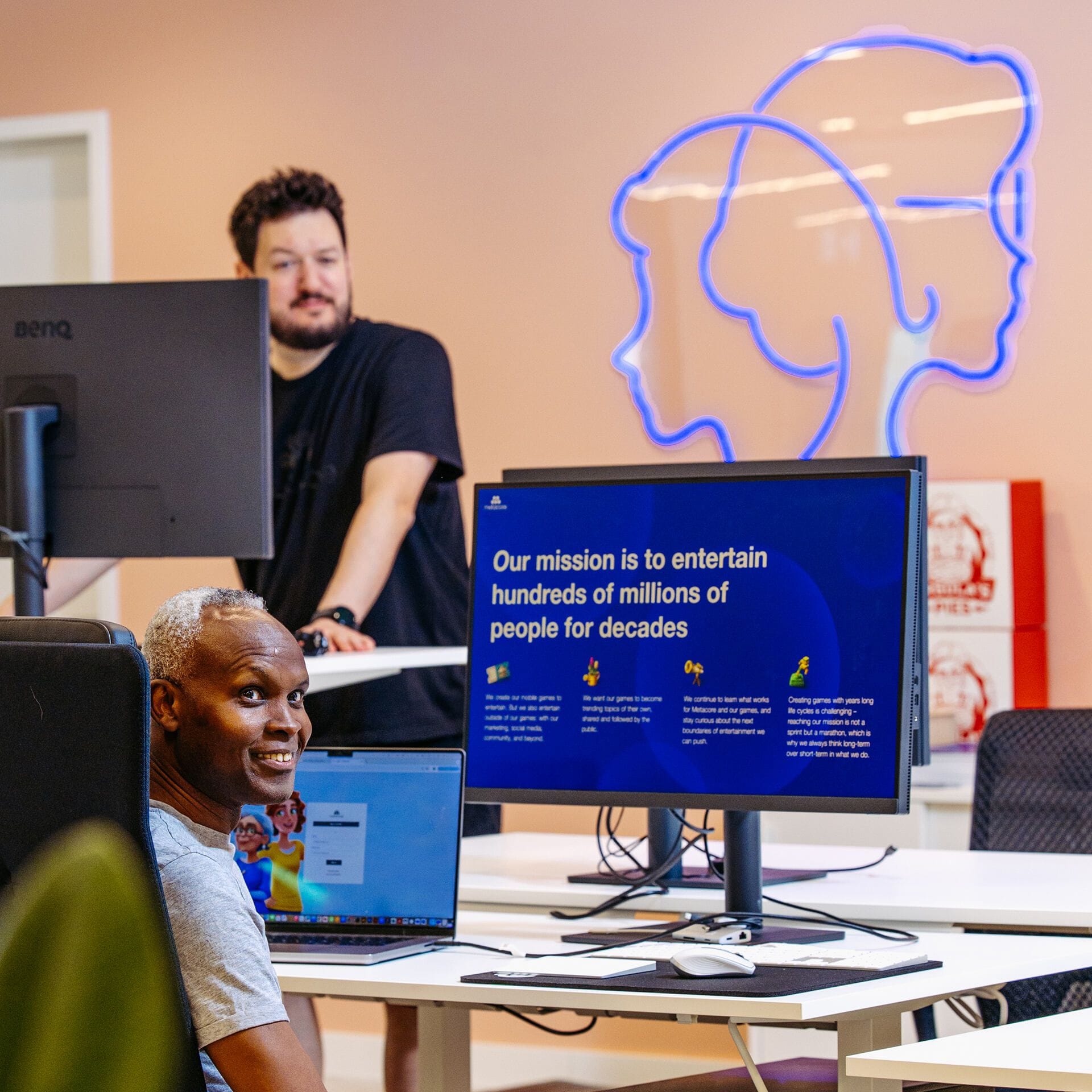 Metacoreans looking back from their desks in the Berlin office