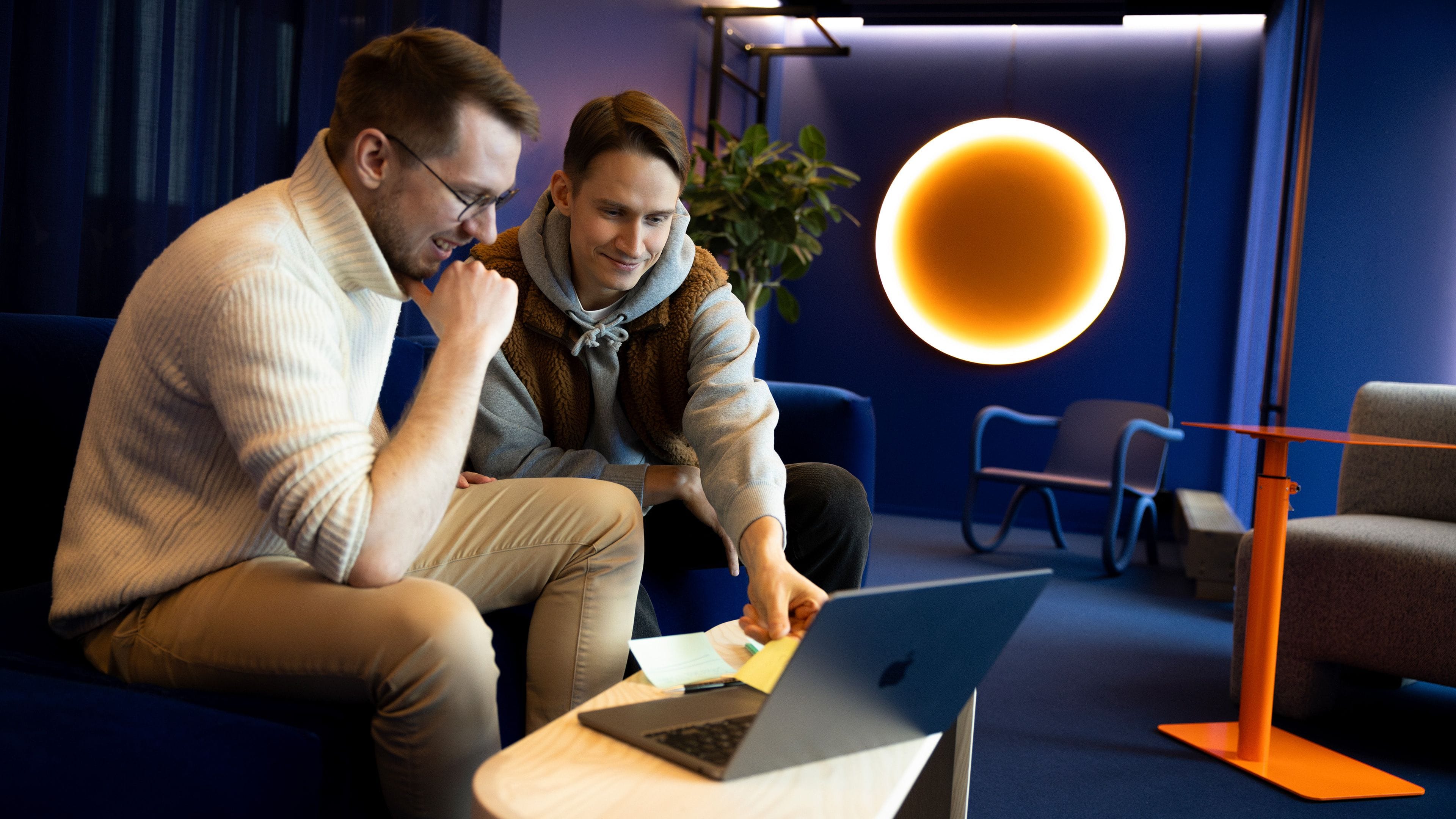 Two people looking at a laptop at Metacore office