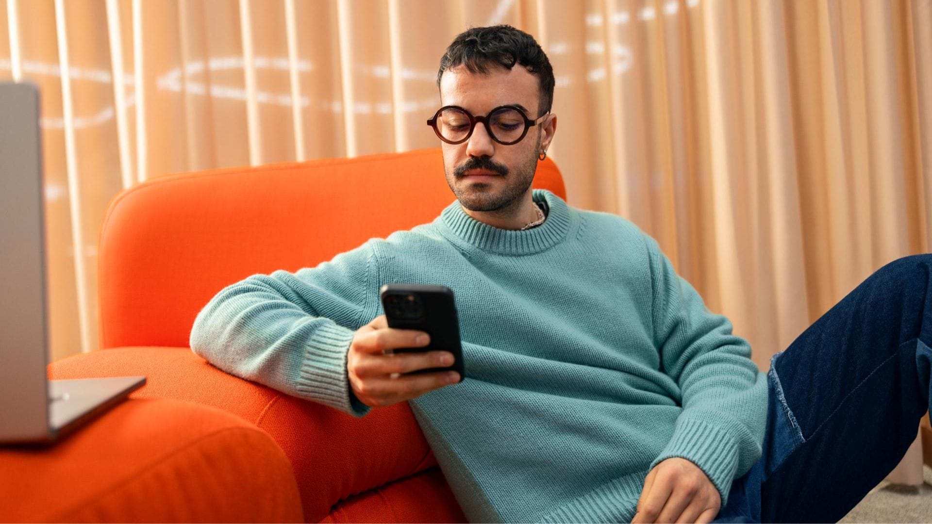 A person at Metacore's very stylish office checking their phone.