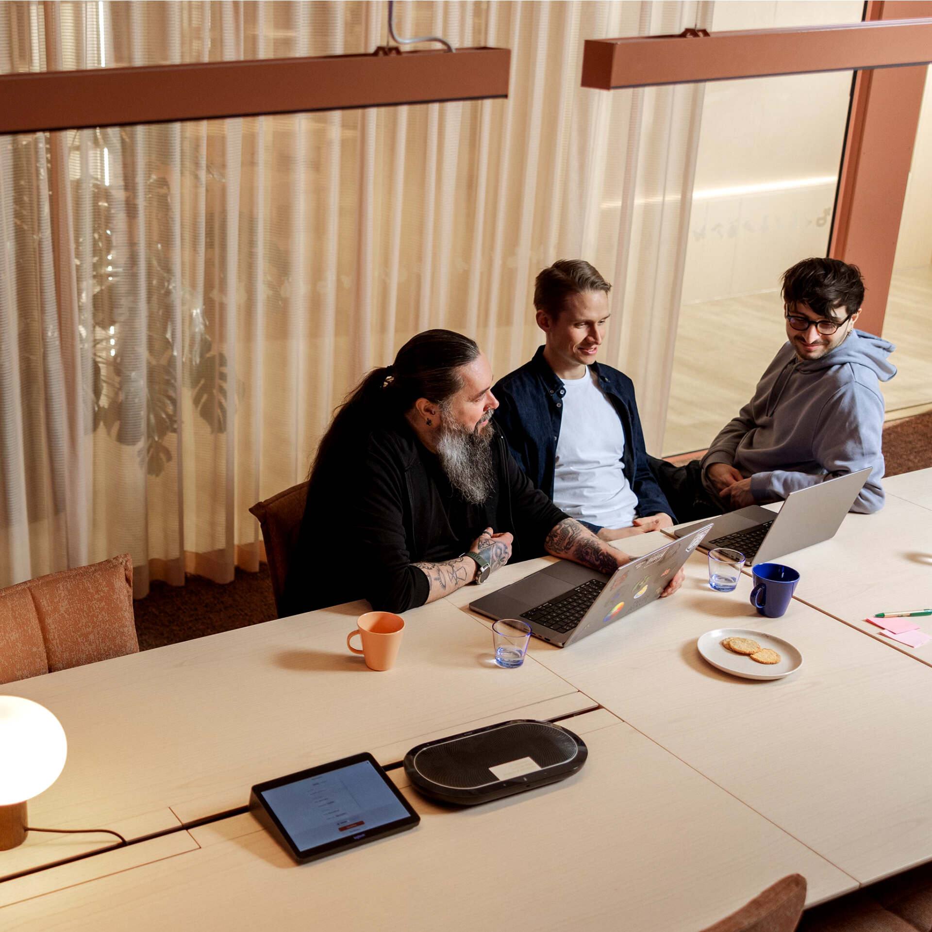 Metacoreans sitting by a large conference table
